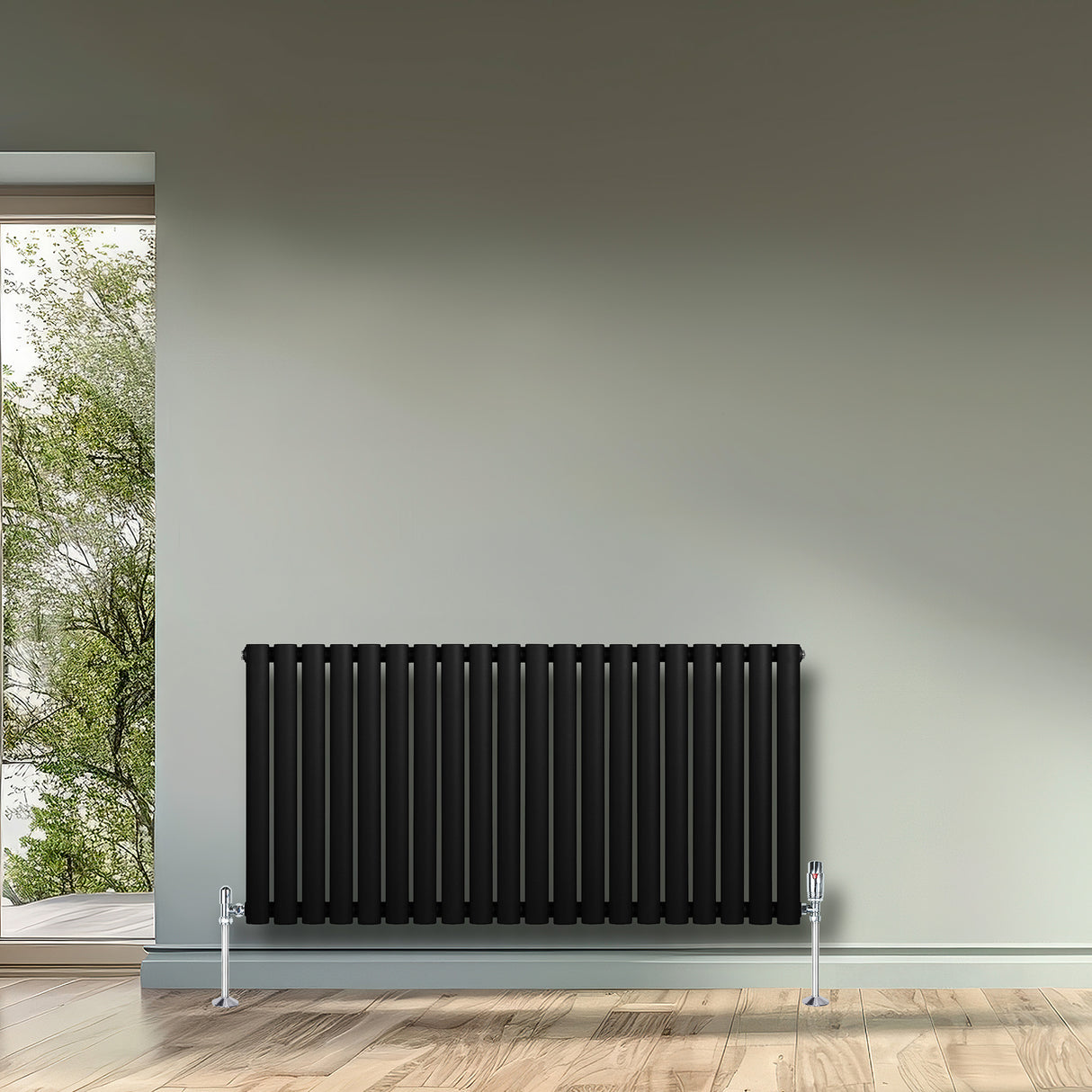 Ovale zwarte design radiator met één kolom, 600 mm x 1200 mm, geplaatst tegen een lichte muur in een moderne ruimte