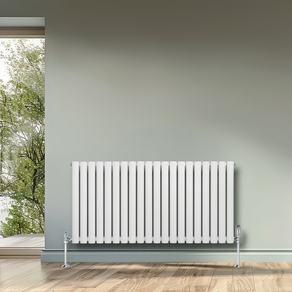 Ovale witte designradiator met één kolom, 600 mm x 1200 mm, geplaatst tegen een groene muur met houten vloer en natuurlijk licht