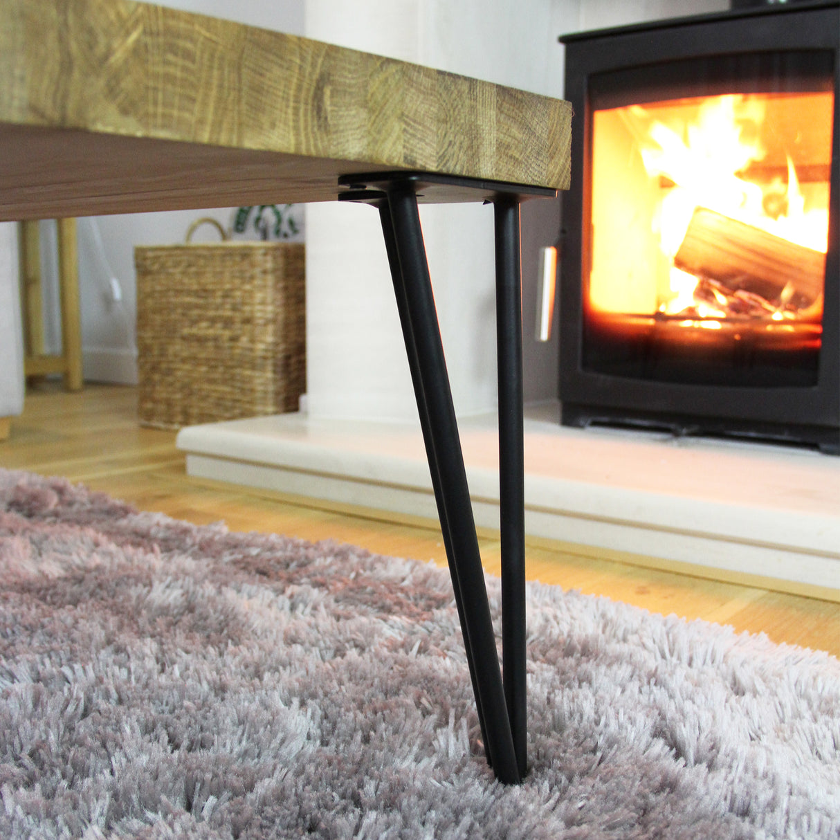 Zwarte hairpin tafelpoten van 35,5 cm met een slanke, moderne uitstraling, geplaatst onder een houten tafel in een gezellige woonkamer