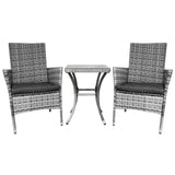 Twee moderne wicker stoelen met grijze kussens en een bijpassende glazen tafel, perfect voor een stijlvolle buitenruimte