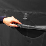 Zwarte tas met een hand die een zak opent, zichtbaar mesh vak en gladde stof, ideaal voor het opbergen van accessoires