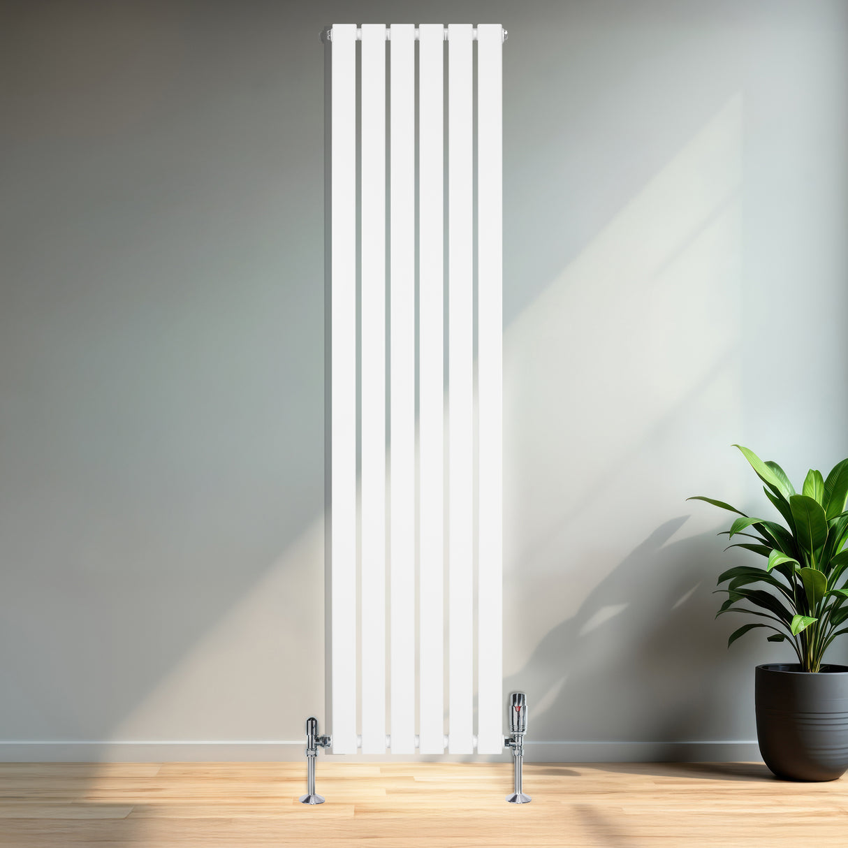 Strakke, witte design radiator met vlakke panelen en haakse thermostaatkraan, geplaatst tegen een lichte muur in een moderne ruimte