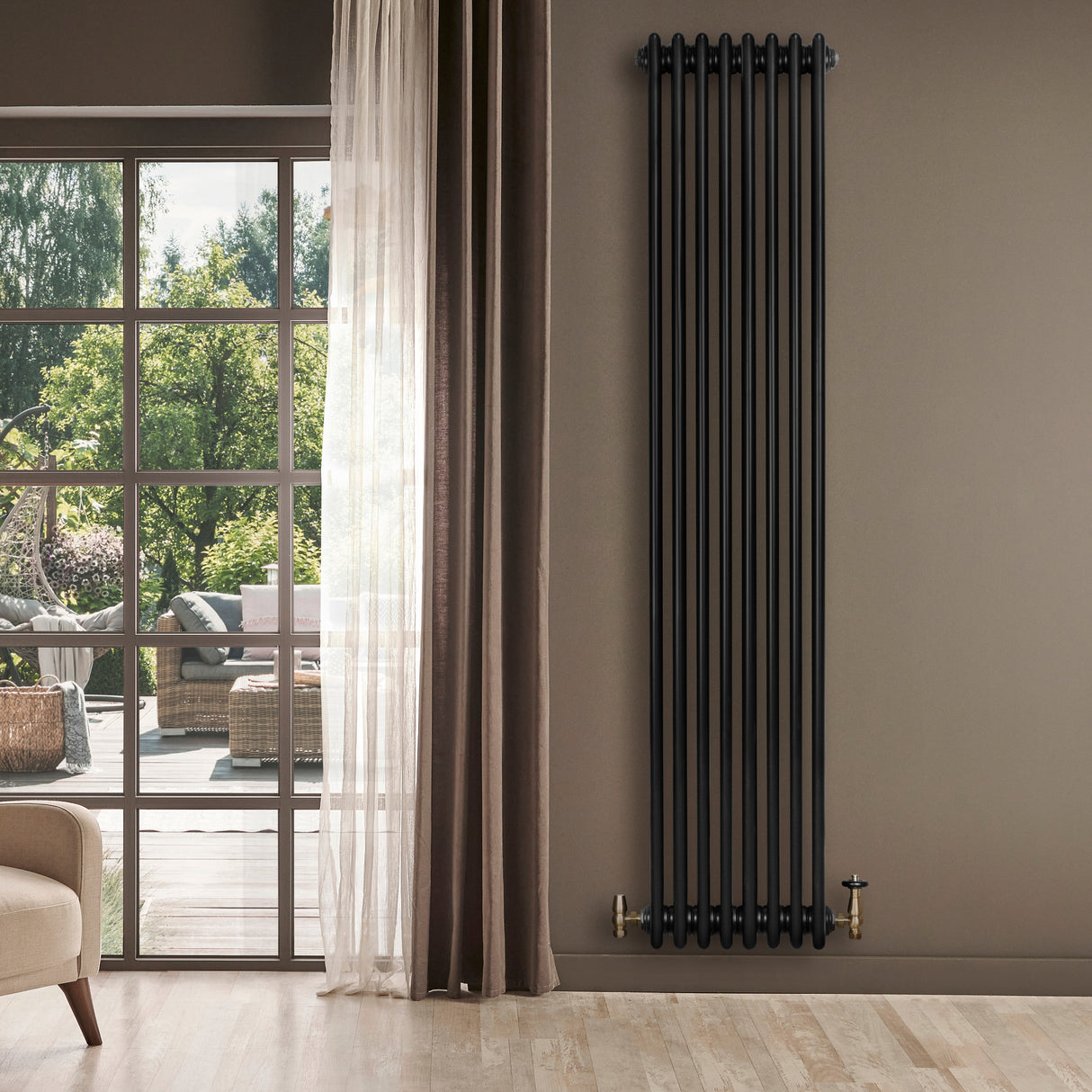 Traditionele zwarte 4-kolom radiator van 1800 x 380 mm, met een glanzende afwerking en stijlvolle messing aansluitingen, tegen een neutrale muur