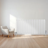 Witte design radiator met vlakke panelen en één kolom, geplaatst tegen een lichte muur naast een moderne stoel op houten vloer