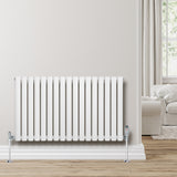 Ovale witte design radiator met één kolom, 600 mm x 1020 mm, geplaatst tegen een lichte muur in een moderne woonkamer