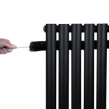 Zwarte ovale design radiator met één kolom, 1800 mm x 600 mm, met een hand die een borstel gebruikt voor onderhoud