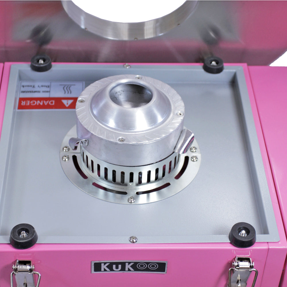 Roze Kukoo popcornmachine met een glanzende metalen popcornautomaat en een veiligheidssymbool, ideaal voor feestjes en evenementen